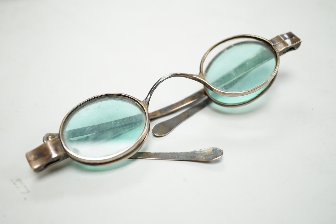A pair of George IV silver turn pin hinged spectacles with tinted and clear double folding lenses, mm. H.I, London 1825, card case